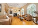 Bright living room with fireplace, built-in shelving, and arched windows, providing an inviting space at 101 Royal Glen Dr, Cary, NC 27518