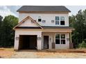 Two-story home featuring an attached garage, and new windows, awaiting completion at 103 Goldenrod Loop, Clayton, NC 27520