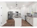 Bright kitchen features stainless steel appliances, granite counters, and a functional island at 103 Goldenrod Loop, Clayton, NC 27520