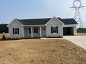Charming single-story home with a two-car garage and manicured front lawn at 1036 Turlington Rd, Dunn, NC 28334