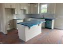Bright kitchen featuring white cabinets, an island, and modern finishes at 1036 Turlington Rd, Dunn, NC 28334