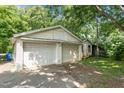 Spacious two-car garage with ample parking space, side garage door and blue garbage bin at 1090 S Fifth St, Mebane, NC 27302