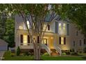 Charming two-story home exterior featuring a welcoming front porch and inviting curb appeal at dusk at 121 Fort Jackson Rd, Morrisville, NC 27560