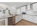 Modern kitchen has stainless appliances, white cabinets, and granite counters with a breakfast bar at 144 N White St # 100, Wake Forest, NC 27587