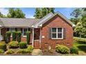 Close-up of a charming brick home featuring a well-kept front yard and an inviting entryway at 1731 Malone Rd # A, Burlington, NC 27215