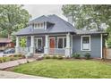 Cozy home with a covered porch, classic columns, and a well-manicured lawn at 2031 Englewood Ave, Durham, NC 27705