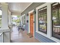 Relaxing covered porch with seating, stylish lighting, and a view of the neighborhood at 2031 Englewood Ave, Durham, NC 27705
