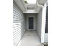 Covered entryway featuring a dark front door, offering protection from the elements at 2039 Alderman Way, Creedmoor, NC 27522