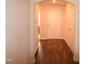 Inviting hallway with beautiful wood floors, leading to various rooms in the home at 2039 Alderman Way, Creedmoor, NC 27522