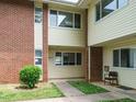 Two-story townhouse featuring brick and siding exterior with walkway to unit entrance at 2316 Champion Ct, Raleigh, NC 27606