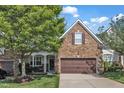 Charming townhome exterior with a stone facade, lush lawn, and a well-manicured front yard at 240 Meadow Beauty Dr, Apex, NC 27539