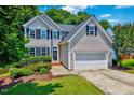 Charming two-story home with manicured lawn, attached two-car garage, and well-maintained landscaping at 2501 Springfield Park Dr, Raleigh, NC 27614