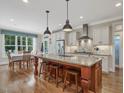 Bright kitchen features a large central island with seating, granite countertops, and stainless steel appliances at 259 Brown Bear, Chapel Hill, NC 27517
