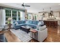 Open-concept living area featuring hardwood floors and a large window that provides natural light and backyard views at 259 Brown Bear, Chapel Hill, NC 27517