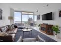 Cozy living room with balcony access and city views at 301 Fayetteville St # 2611, Raleigh, NC 27601