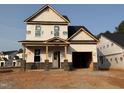Exterior shot of new construction home featuring brick foundation and attached garage at 325 Bluejay St, Clayton, NC 27520