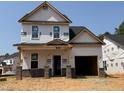 New two-story home featuring a brick pillar front porch and attached two car garage under construction at 325 Bluejay St, Clayton, NC 27520