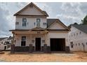New two-story home under construction features a front porch with brick supports and an attached two-car garage at 325 Bluejay St, Clayton, NC 27520