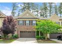 Charming brick townhome featuring a two-car garage and well-maintained landscaping at 329 Castle Rock Ln, Cary, NC 27519