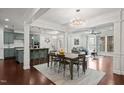 Open concept living and dining with kitchen, decorative lighting, and comfortable seating at 329 Castle Rock Ln, Cary, NC 27519