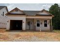 New construction home featuring a modern design, large garage and covered front porch at 335 Bluejay St, Clayton, NC 27520