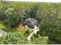 Stunning aerial view of a stately home nestled amidst lush green forest and landscaping at 3587 Garner Terrace Way, Wake Forest, NC 27587