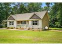 Charming single-story home featuring a front porch, manicured lawn, and a propane tank discreetly placed at 39 Blue Heron Ct, Kenly, NC 27542