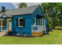 The brick home features a small porch, tasteful landscaping and an inviting atmosphere at 408 N Maple St, Graham, NC 27253