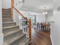 Bright living room featuring hardwood floors, a fireplace, and an open floor plan at 412 Heritage Village Ln, Apex, NC 27502