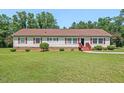 Charming ranch-style home with red shutters, a well-manicured lawn, and mature trees, perfect for a serene living at 4403 Jeffries Rd, Durham, NC 27704