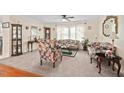 Inviting living room with a cozy seating arrangement, complemented by a ceiling fan and natural light filtering through the windows at 4403 Jeffries Rd, Durham, NC 27704