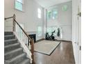 Open-concept living room with hardwood floors, fireplace, and a staircase at 5105 Carolwood Ln, Durham, NC 27713