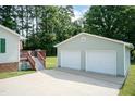 Spacious two-car detached garage with adjacent deck and mature trees offers privacy at 523 Edwards Rd, Henderson, NC 27537