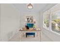 Bright and airy office space with a large window, a neutral color scheme, and a stylish desk setup at 5545 Moneta Ln, Apex, NC 27539