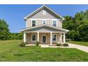Charming two-story home with covered porch and swing; tidy landscaping at 567 E Ridge Ave, Liberty, NC 27298