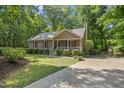 Inviting home showcasing well-maintained landscaping and a quaint, covered front porch area at 6009 Shadow Moss Cir, Raleigh, NC 27603