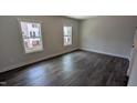 The bedroom offers natural light from two windows and features beautiful hardwood floors at 659 Bandon Aly, Cary, NC 27513