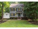 Two-story home with gray siding, black shutters, and a well-manicured lawn at 7604 Copper Creek Ct, Wake Forest, NC 27587