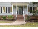 Charming home exterior with a welcoming front porch and well-maintained landscaping at 7604 Copper Creek Ct, Wake Forest, NC 27587