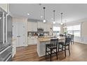 Bright kitchen featuring a large center island, granite countertops and modern stainless steel appliances at 80 Shallow Falls Ln, Benson, NC 27504