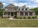 Charming two-story brick home with a welcoming front porch and manicured lawn at 814 Covered Bridge Trl, Chapel Hill, NC 27517