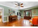 Elegant entryway featuring dark wood accents, decorative mirror, and vintage piano at 821 Woodburn Rd, Raleigh, NC 27605