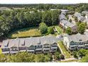 An aerial view of townhomes with manicured lawns and green spaces, creating a serene and well-maintained community at 1017 Frank Page Dr, Cary, NC 27511