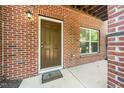 Brick porch with a brown door and window is adjacent to a wall at 1017 Frank Page Dr, Cary, NC 27511