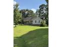 Inviting single-story home with a covered front porch and a well-manicured lawn at 104 Holly Ranch Ct, Willow Springs, NC 27592