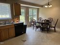 Kitchen dining area with table, chairs, and natural light from multiple windows at 104 Holly Ranch Ct, Willow Springs, NC 27592