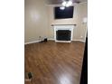 Cozy living room with hardwood floors, fireplace and mounted television at 104 Holly Ranch Ct, Willow Springs, NC 27592