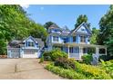 Charming two-story home with light blue siding, white trim, front porch, and an attached two car garage at 104 Shady Ridge Ct, Apex, NC 27502