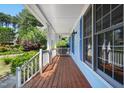 Inviting front porch with stained wood flooring, blue siding, white railing, and ample space for relaxing at 104 Shady Ridge Ct, Apex, NC 27502