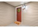 Inviting entryway with a classic door, wreath, 'hello' mat, and stylish sconce lighting at 106 Choptank Ct # B-2, Cary, NC 27513